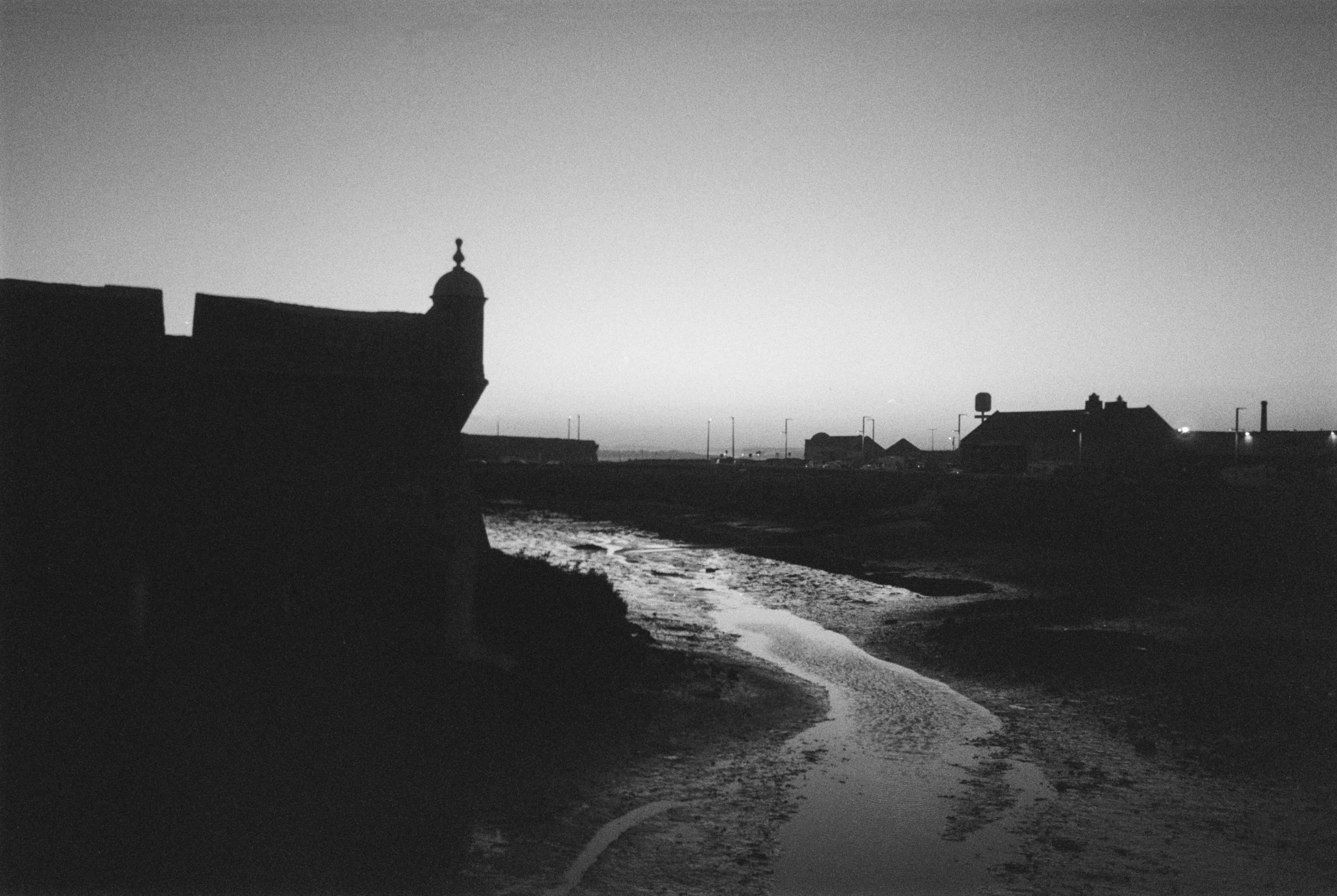 black a white picture of Peniche's old town wall by the dawn