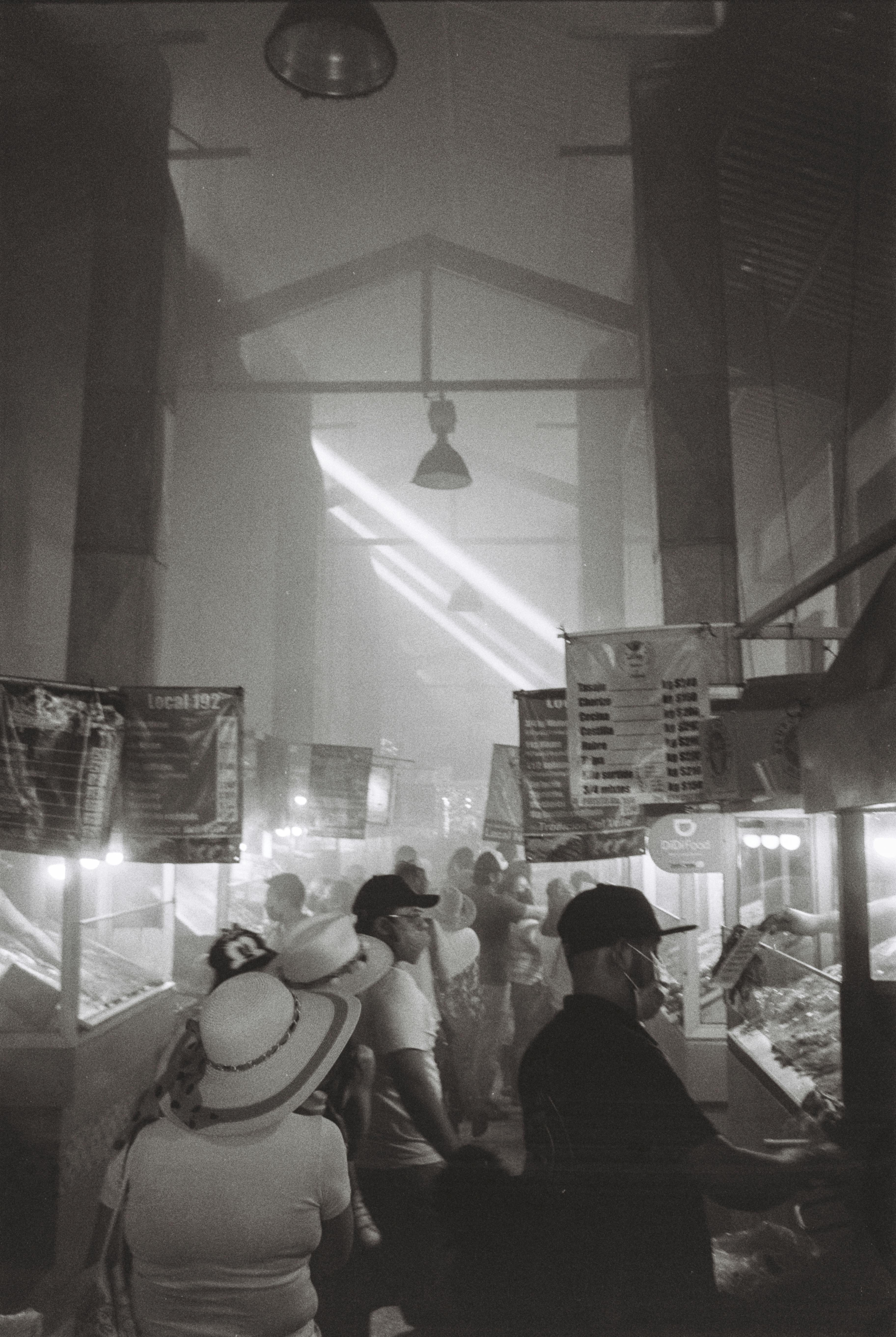 Black and white picture of a market hall full of smoke